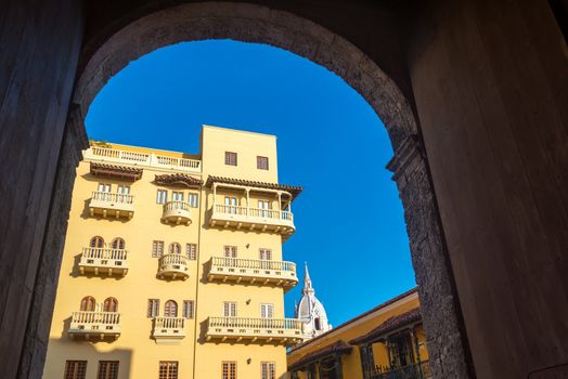 View of colonial balconies as seen from a high arching doorway in the historic center of Cartagena