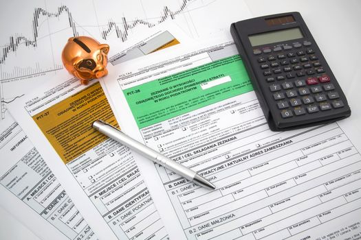 Polish income tax forms with calculator and piggybank