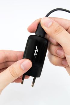 Man using black USB phone charger