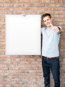 Young man holding blank whiteboard on business presentation