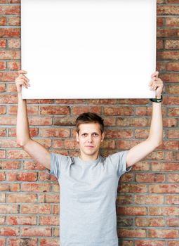 Young man holding blank whiteboard on business presentation