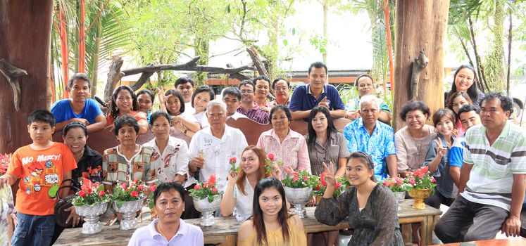 KRABI, THAILAND - APRIL 16: Unidentified Thai people to take a group picture after celebrate Songkran (new year / water festival) by giving garlands to their seniors and asked for blessings on April 16, 2013 in Krabi, Thailand.