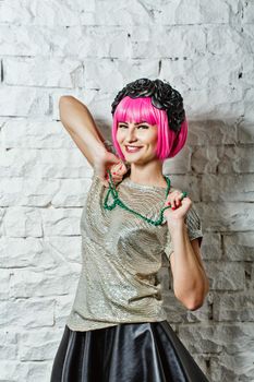Attractive young girl with rim on head holding beads