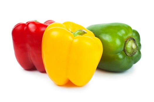 Three sweet peppers red, green and yellow over white background