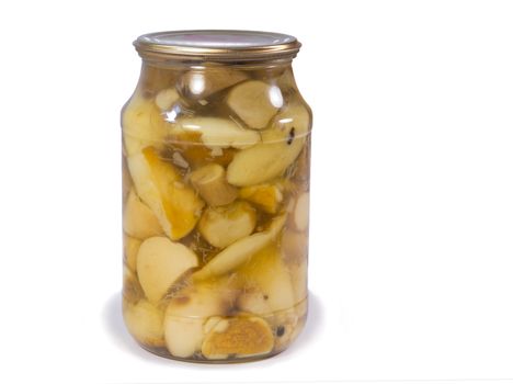 Home canning of foods - pickled mushrooms in a glass jar. Presented on a white background.