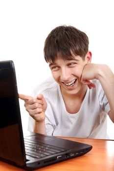 Doubtful Teenager showing the Finger to Laptop Screen Isolated on the White