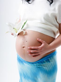 Pregnant young woman with a big belly. standing