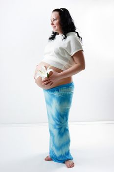 Pregnant young woman with a big belly. standing