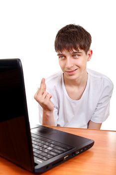 Young Man Shows Middle Fingers Gesture at the Desk with Laptop. Isolated