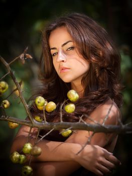 Soft portrait of young woman with wild apples