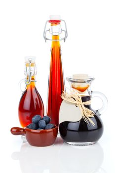 blueberry syrup in glass bottle or mixture, with heart label. on white background.
