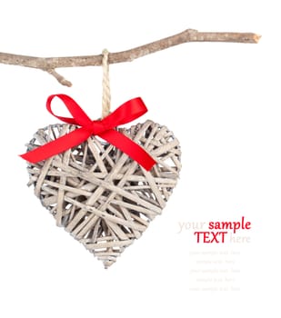 Heart shaped decoration made of wood, over white background