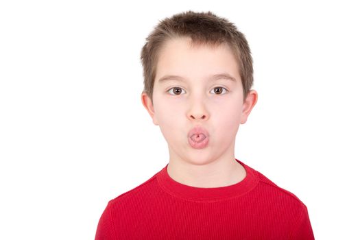 Playful young boy sticking out his tongue in a mischievous gesture or in an act of rudeness isolated on white