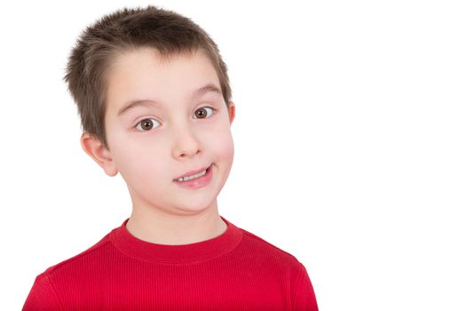 Skeptical young boy reacting in disbelief smiling ruefully and raising an eyebrow, isolated on white