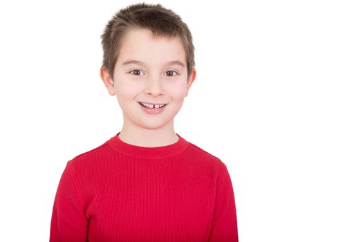 Young boy in a red t-shirt with a happy grin and alert expression, isolated on white