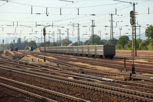 Many railway tracks with freight wagons