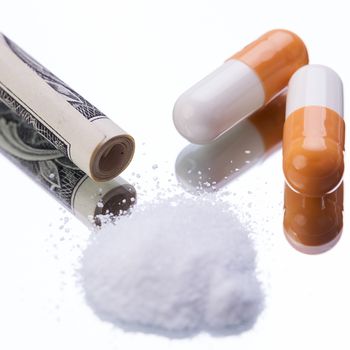 illegal pharmaceutical pills and drugs money on mirror addiction objects