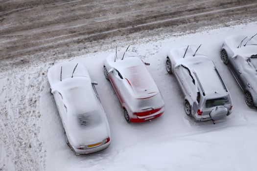 Parking cars covered by a lot of snow