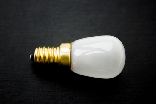 Light bulb on a black background.