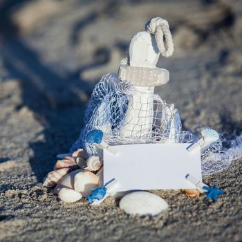 sailing boat and seashell in sand decoration closeup holiday background