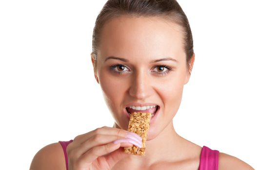 Sexy young woman eating a cereal bar, isolated in white