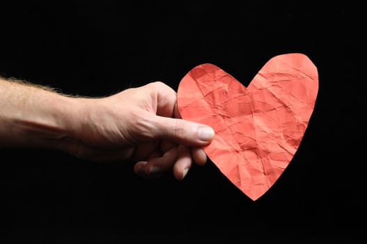 Heart And an Hand on a Black Background