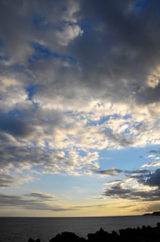 Some Colored Clouds over the Ocean on a Blue Sky