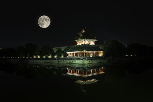 The watchtower of the Forbidden City under the moon light in Beijing, China