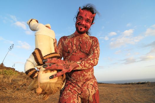 Latin American Man with Long Hairs Masked as a Devil in the Desert