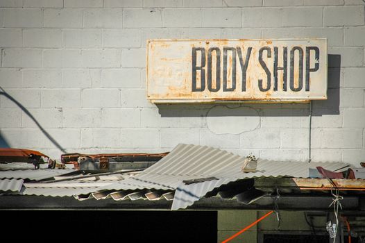 Recession Image Of Grungy Sign For A Rundown Body Shop