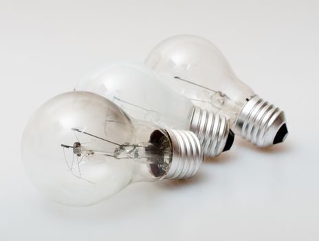 Three Aged Burnt Bulbs on Light Background - Shallow Depth of Field