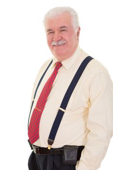 Confident relaxed senior man wearing braces standing smiling at the camera with his hands in his pocket