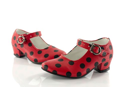 red shoes from back with black dots and white background