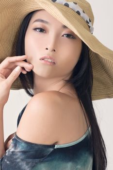 Glamour of Asian beauty with hat, closeup portrait.