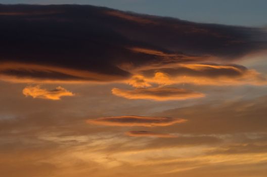 Clouds playing with orange,red and pink colors at sunset in Crete