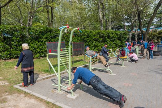 Shanghai, China - April 7, 2013: group of people exercising in fuxing park at the city of Shanghai in China on april 7th, 2013