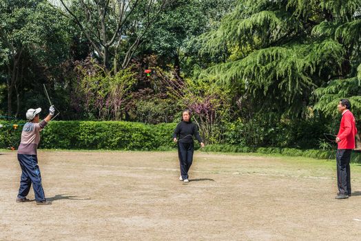 Shanghai, China - April 7, 2013: old people playing diabolo in fuxing park at the city of Shanghai in China on april 7th, 2013