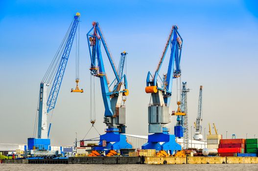 Large industrial cargo cranes in the sea harbor