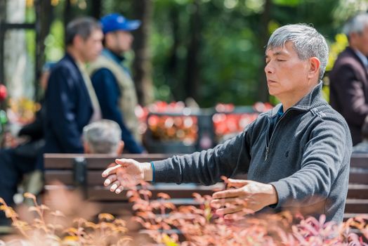 Shanghai, China - April 7, 2013: one man exercising meditation in fuxing park at the city of Shanghai in China on april 7th, 2013