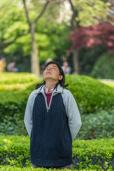 Shanghai, China - April 7, 2013: one woman exercising meditation in fuxing park at the city of Shanghai in China on april 7th, 2013