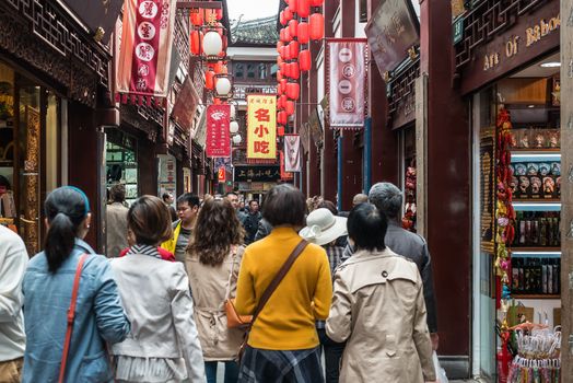 Shanghai, China - April 7, 2013: people walking in street of Fang Bang Zhong Lu at the old city of Shanghai in China on april 7th, 2013