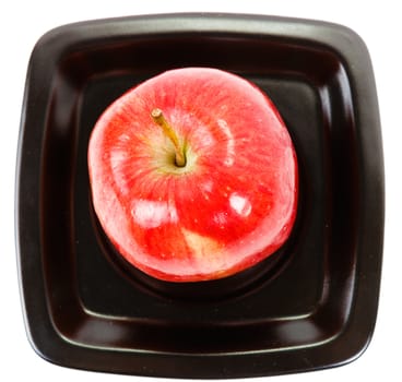 red apple on a black plate. top view