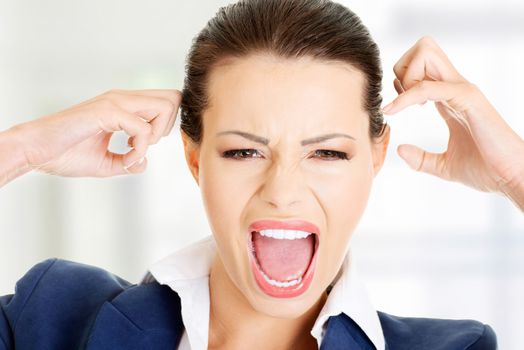 Stressed or angry businesswoman screaming loud , isolated on white