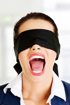 Portrait of a beautiful frighten young blindfold woman screaming