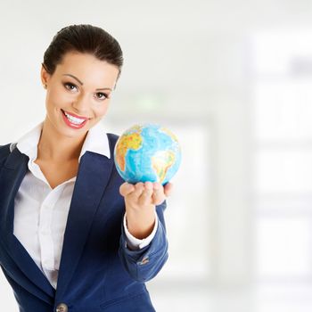 Young smiling businesswomen with globe