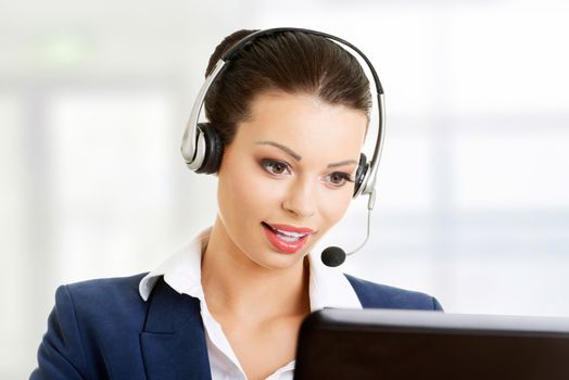 Beautiful young call-center assistant smiling , isolated on white