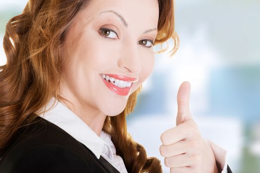 Happy smiling business woman with thumbs up, ok gesture