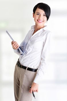 Happy smiling business woman or student in elegant clothes holding notebook and pen, isolated on white background