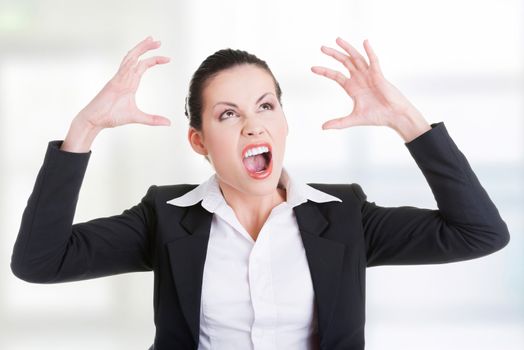 Stressed or angry businesswoman screaming loud