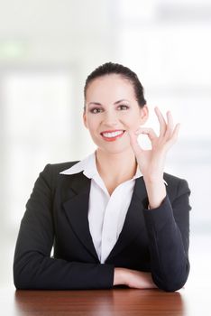 Young woman at the desk gesturing perfect , isolated on white